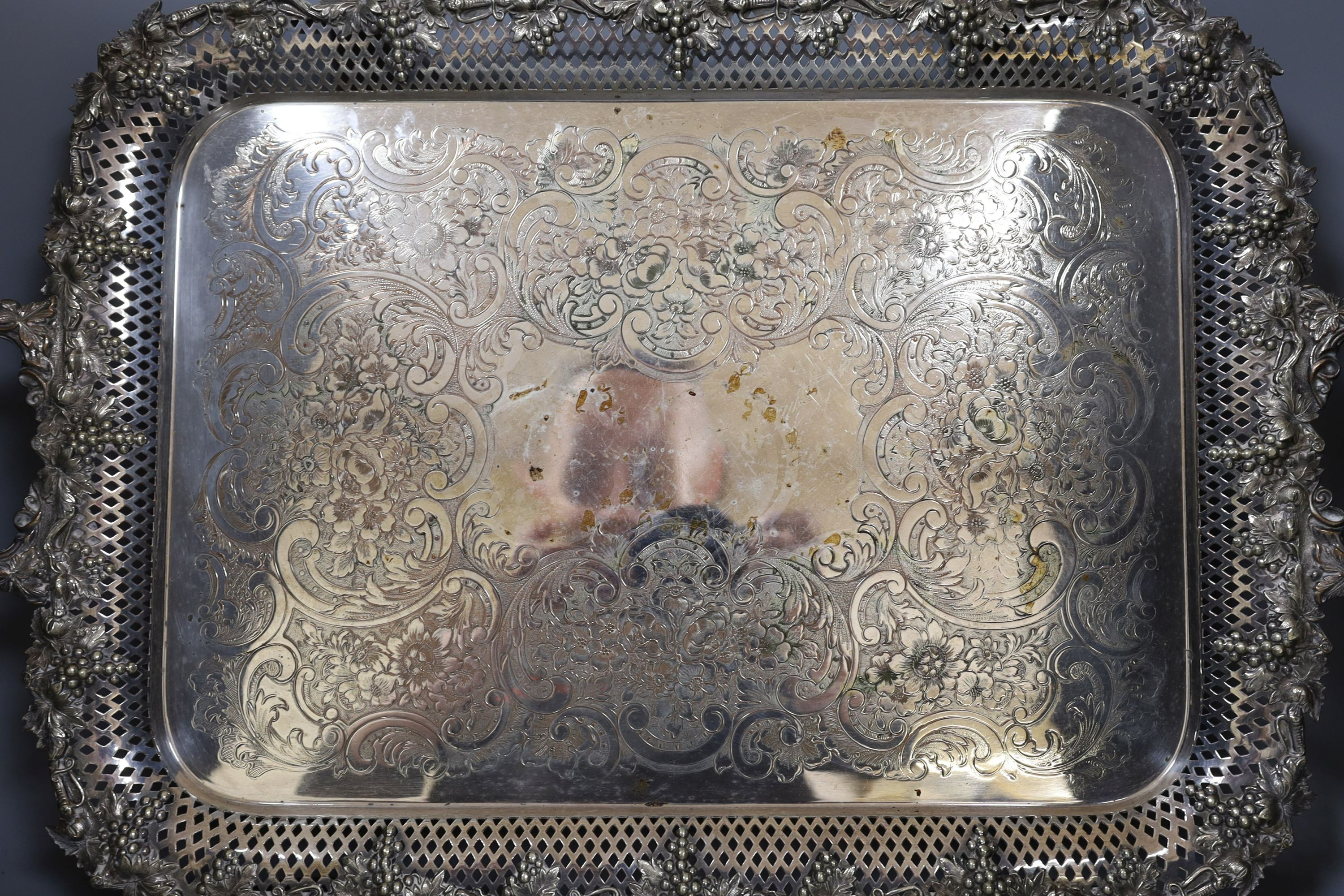 A large electroplate two handled tray, with pierced and vine decoration, 51 cms wide not including handles.